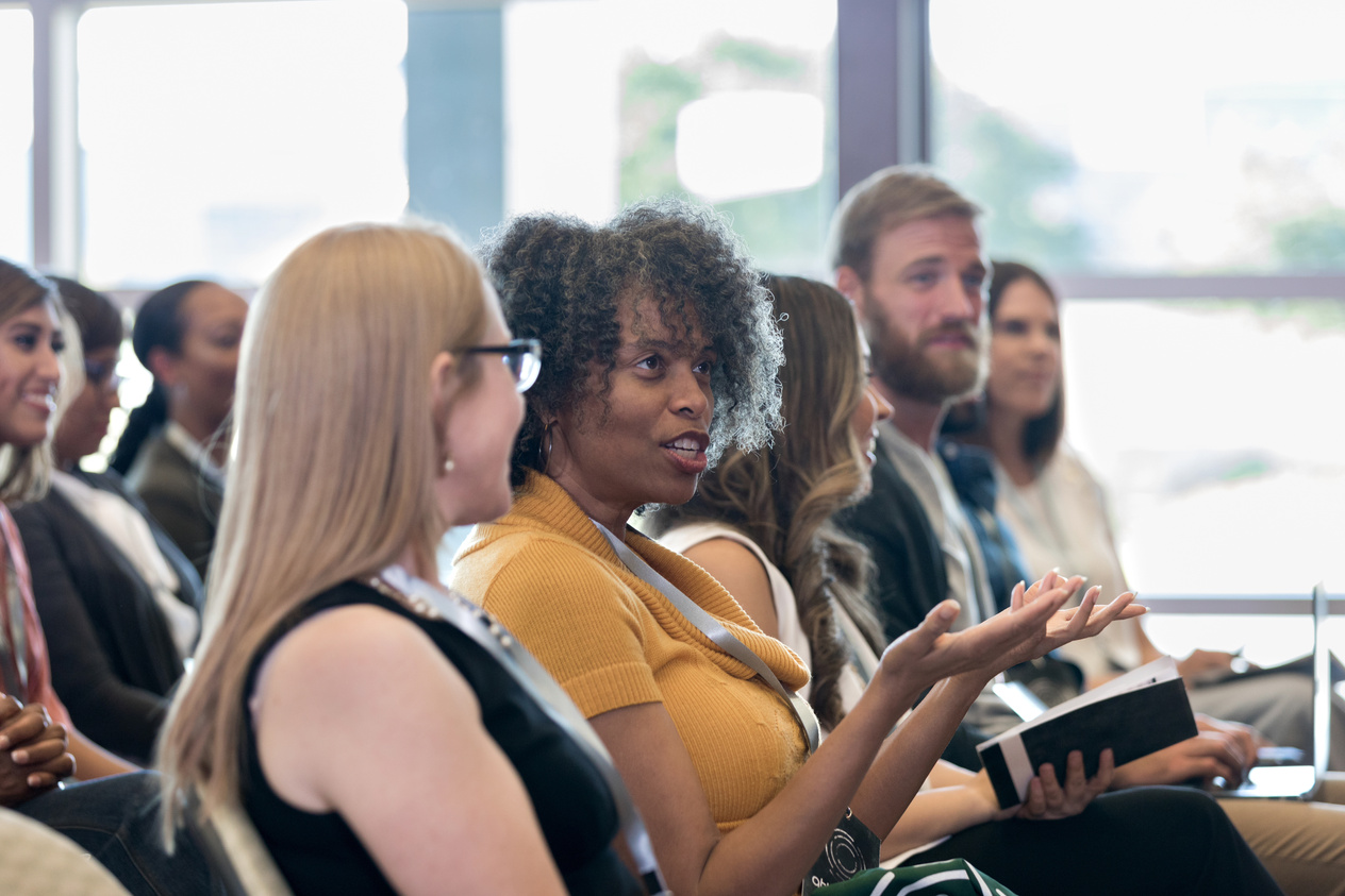 Conference attendee asks question during conference